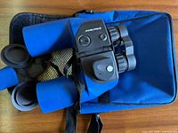 Top view of binoculars lying on blue carry case