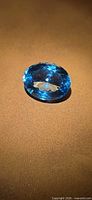 Oblique view of oval Swiss blue topaz showing color and faceting