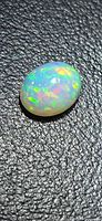 Top view of oval cabochon opal showing vivid multi-color play-of-color