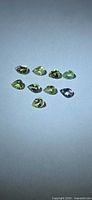 Group of pear-cut lemon-lime stones illustrating color and cut