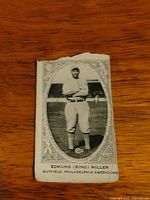 Front of 1922 E120 Bing Miller card showing image, caption, frame, and top edge damage