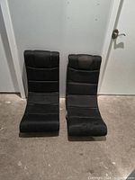 Front view of two black X Rocker floor chairs