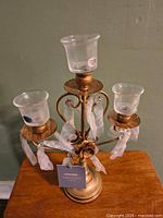 Opened Amalfi Décor bronze candelabra showing three glass cups and hanging drops