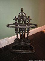 Front view of entire ornate cast iron stand