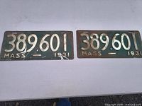 Two 1931 Massachusetts license plates number 389601 on table