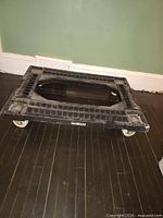 Top view of Weston plastic cargo dolly showing frame and casters