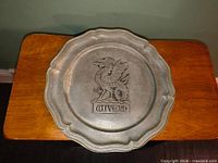 Front view showing wivern design and scalloped rim