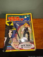 Front view of sealed Dick Tracy action figure on card with accessories visible
