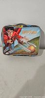 Front view of soft Harry Potter lunchbox showing Quidditch graphic