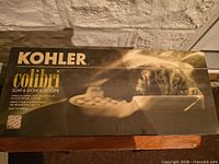 Front of sealed Kohler Colibri soap & sponge holder box