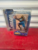 Front view of sealed Allen Iverson Series 12 action figure showing figure and packaging