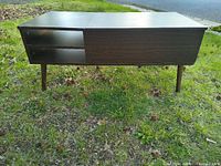 Overall view of dark walnut lift-top coffee table closed