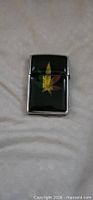 Front view of black Zippo lighter with rasta cannabis leaf graphic
