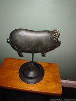 Front view of flat metal pig on stand