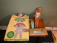 All three items: Cabbage Patch Kids paper doll box, Barbie doll, St. Labre doll with envelope