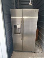 Front view of stainless steel Whirlpool side-by-side refrigerator-freezer