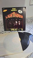 Front cover of K-tel Presents Lighthouse jacket with LP partially visible