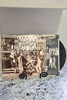 Front jacket and partial vinyl visible on stand