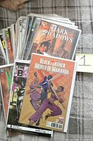 Stack of bagged comic books, top issues Dark Shadows and Black Panther: World of Wakanda #2