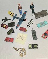 Overall group of die-cast cars, aircraft, military vehicles, action figures, launcher accessory