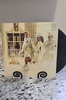 Front cover of Cheap Trick Dream Police vinyl LP partially showing black vinyl record