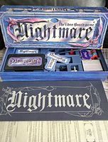Open box showing Nightmare VHS cassette, card decks, plastic insert with pawns, board and rule sheet
