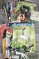 Front view of stacked comics showing Green Lanterns #4 and other DC titles