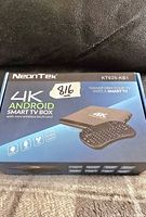 Front of sealed box showing brand, model, 4K Android Smart TV Box with mini wireless keyboard