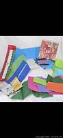 Group of assorted coloured tissue paper sheets and one sealed pack