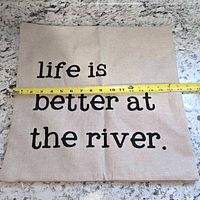 Front view of pillow cover with tape measure showing ~18 in width