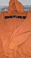 Front view of orange hoodie with BEARS lettering