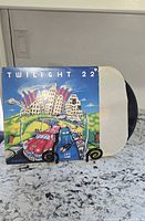 Front album jacket and vinyl partially visible