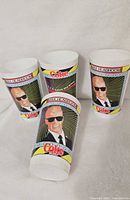 Four vintage Coca-Cola paper cups featuring Max Headroom graphic