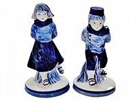 Front view of both Delft skater figurines