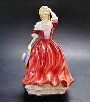 Front view of Paragon Spring figurine showing dress detail and hat