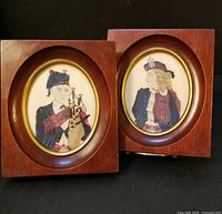 Both framed needlepoint pictures side by side showing overall design and frame style.