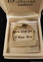Gold ring in lined case showing branding and sentiment