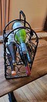 Front angled view showing metal wine rack holding three example bottles