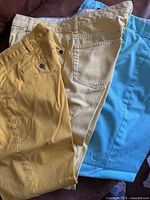 Three pairs of capris laid out showing colors and style