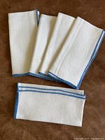 All five folded linen napkins displayed