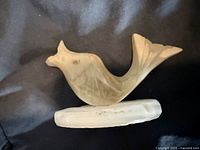 Left side view of alabaster fish figurine on base