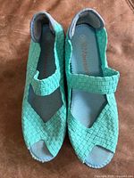 Top view showing teal woven uppers and size marking