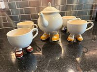Full set showing teapot and four cups