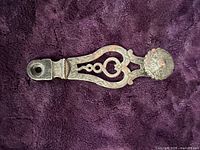 Front view of decorative iron window latch fragment