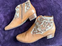 Side profile of both boots showing leather and appliqué canvas panels