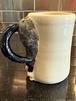 Side view of mug showing horse hindquarter and tail handle