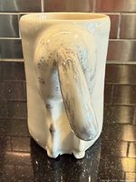Rear view showing sculpted horse hindquarters and tail on mug