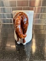 Rear view showing sculpted horse tail handle