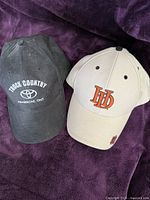 Front view of both caps showing logos and colors