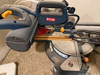 Overall view of Ryobi 10-inch miter saw showing handle, motor housing and blade